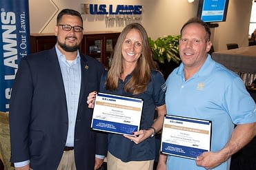 David Wells (left) pictured with two new U.S. Lawns franchisees